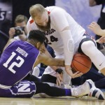 Northwestern guard Isiah Brown (12) and Gonzaga center Przemek Karnowski (24) scramble for a loose ball during the first half of a second-round game in the NCAA men's college basketball tournament Saturday, March 18, 2017, in Salt Lake City. (AP Photo/Rick Bowmer)
