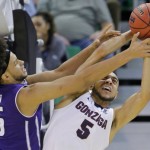 Gonzaga guard Nigel Williams-Goss (5) and Northwestern center Barret Benson (25) battle for a rebound during the first half of a second-round college basketball game in the men's NCAA Tournament Saturday, March 18, 2017, in Salt Lake City. (AP Photo/Rick Bowmer)