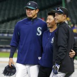 Miami Marlins' Ichiro Suzuki, right, poses for a photo with Seattle Mariners pitcher Hisashi Iwakuma, left, and Mariners translator Antony Suzuki, center, before batting practice prior to a baseball game against Ichiro's former team, the Seattle Mariners, Monday, April 17, 2017, in Seattle. (AP Photo/Ted S. Warren)