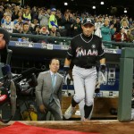 Miami Marlins' Ichiro Suzuki steps out of the visitors dugout to be honored by Seattle Mariners players and executives for his 3,000 hit milestone in a pre-game ceremony before a baseball game against the Mariners, his former team, Monday, April 17, 2017, in Seattle. (AP Photo/Ted S. Warren)
