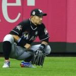 Miami Marlins' Ichiro Suzuki crouches in left field at the start of a baseball game against the Seattle Mariners, Monday, April 17, 2017, in Seattle. (AP Photo/Ted S. Warren)