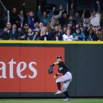 Fans cheer as Miami Marlins left fielder Ichiro Suzuki throws after fielding an RBI double hit by Seattle Mariners' Robinson Cano in the fourth inning of a baseball game, Monday, April 17, 2017, in Seattle. (AP Photo/Ted S. Warren)