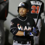 Miami Marlins' Ichiro Suzuki holds his bat and looks to the scoreboard while walking in the dugout after grounding out in the eighth inning of a baseball game against the Seattle Mariners, Monday, April 17, 2017, in Seattle. Suzuki was 0-3 at the plate and the Mariners beat the Marlins 6-1. (AP Photo/Ted S. Warren)