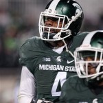 Michigan State defensive lineman Malik McDowell reacts after returning an interception for a touchdown during the fourth quarter of an NCAA college football game against Penn State, Saturday, Nov. 28, 2015, in East Lansing, Mich. Michigan State won 55-16. (AP Photo/Al Goldis)