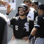 
              Chicago White Sox's Yolmer Sanchez (5) is greeted in the dugout after he scored on a single by Matt Davidson in the first inning of a baseball game against the Seattle Mariners, Sunday, May 21, 2017, in Seattle. (AP Photo/Ted S. Warren)
            