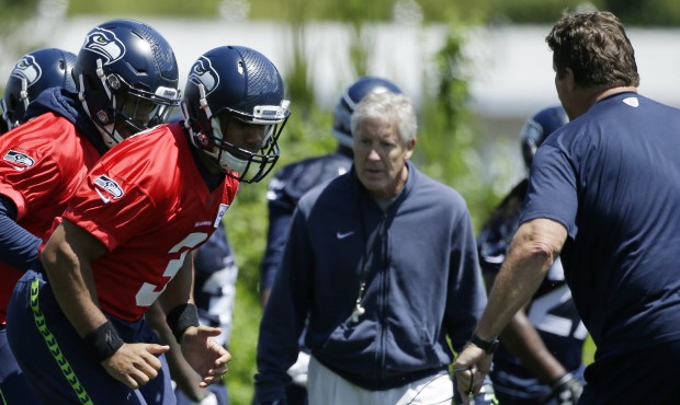 Seattle Seahawks head coach Pete Carroll looks on as Seattle Seahawks quarterback Russell Wilson, c...