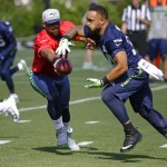 Seattle Seahawks quarterback Russell Wilson hands off to running back Thomas Rawls during an NFL football training camp, Sunday, July 30, 2017, in Renton, Wash. (AP Photo/Ted S. Warren)