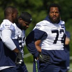 Seattle Seahawks defensive end Michael Bennett (72) talks to teammates during NFL football training camp, Sunday, July 30, 2017, in Renton, Wash. (AP Photo/Ted S. Warren)