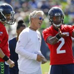 Seattle Seahawks head coach Pete Carroll, center, talks with backup quarterbacks Austin Davis, left, and Trevone Boykin, right, on the first day an NFL football training camp, Sunday, July 30, 2017, in Renton, Wash. (AP Photo/Ted S. Warren)