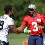 Seattle Seahawks quarterback Russell Wilson (3) greets free safety Earl Thomas (29) before NFL football training camp, Monday, July 31, 2017, in Renton, Wash. (AP Photo/Ted S. Warren)