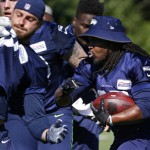 Seattle Seahawks running back Eddie Lacy, right, carries the ball during an NFL football training camp, Monday, July 31, 2017, in Renton, Wash. (AP Photo/Ted S. Warren)