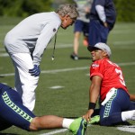 Seattle Seahawks quarterback Russell Wilson, right, talks with head coach Pete Carroll, left, during an NFL football training camp, Monday, July 31, 2017, in Renton, Wash. (AP Photo/Ted S. Warren)