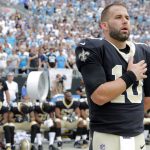 New Orleans Saints quarterback Chase Daniel (10) stands with his hand over his heart during the national anthem as other Saints players sit on the bench before an NFL football game against the Carolina Panthers in Charlotte, N.C., Sunday, Sept. 24, 2017. (AP Photo/Bob Leverone)