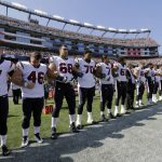 
              Members of the Houston Texans team stand with arms locked during the national anthem before an NFL football game against the New England Patriots, Sunday, Sept. 24, 2017, in Foxborough, Mass. (AP Photo/Steven Senne)
            