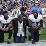 
              Baltimore Ravens wide receiver Mike Wallace, from left, former player Ray Lewis and inside linebacker C.J. Mosley lock arms and kneel down during the playing of the U.S. national anthem before an NFL football game against the Jacksonville Jaguars at Wembley Stadium in London, Sunday Sept. 24, 2017. (AP Photo/Matt Dunham)
            