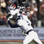 
              Washington State running back James Williams (32) leaps over Nevada defensive back Asauni Rufus (2) during the first half of an NCAA college football game in Pullman, Wash., Saturday, Sept. 23, 2017. (AP Photo/Young Kwak)
            