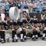 
              New Orleans Saints players sit on the bench during the national anthem before an NFL football game against the Carolina Panthers in Charlotte, N.C., Sunday, Sept. 24, 2017. (AP Photo/Bob Leverone)
            