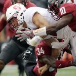
              Washington State defensive back Kirkland Parker (10) and safety Jalen Thompson (34) tackle Stanford quarterback Ryan Burns during the first half of an NCAA college football game in Pullman, Wash., Saturday, Nov. 4, 2017. (AP Photo/Young Kwak)
            