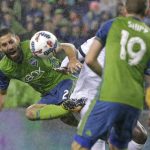 
              FILE - In this Nov. 3, 2017, file photo, Seattle Sounders' Clint Dempsey, left, kicks the ball away from Vancouver Whitecaps midfielder Aly Ghazal as Sounders' Harry Shipp (19) looks on during an MLS soccer Western Conference semifinal match in Seattle. Dempsey has been named the MLS Comeback Player of the Year after a heart condition in 2016 put his career in jeopardy. Dempsey was the choice after scoring 12 goals in the 2017 regular season and leading Seattle to a second-place finish in the MLS Western Conference. The Sounders will face Houston in the Western Conference finals beginning Nov. 21, 2017. (AP Photo/Ted S. Warren, file)
            