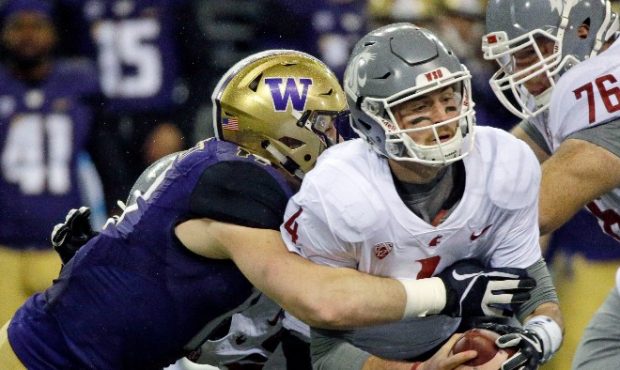 Luke Falk turned the ball over four times in the Apple Cup on Saturday night. (AP)...