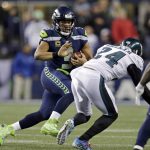 
              Seattle Seahawks quarterback Russell Wilson, left, scrambles as Philadelphia Eagles' Corey Graham (24) moves in during the first half of an NFL football game, Sunday, Dec. 3, 2017, in Seattle. (AP Photo/John Froschauer)
            