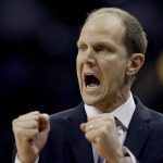 
              Washington coach Mike Hopkins talks to his players during the first half of an NCAA college basketball game against Kansas on Wednesday, Dec. 6, 2017, in Kansas City, Mo. (AP Photo/Charlie Riedel)
            