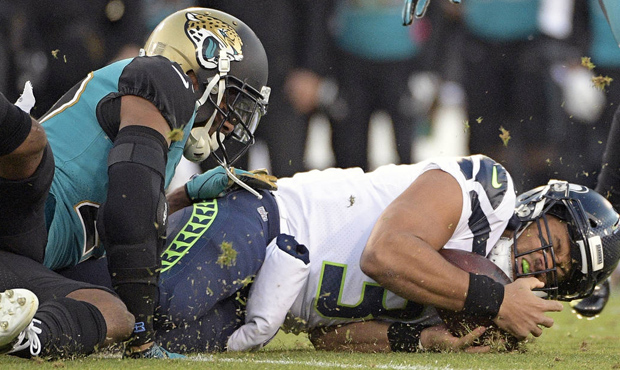 Russell Wilson's three interceptions put the Seahawks in a hole against Jacksonville. (AP)...