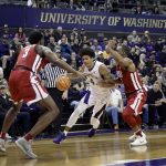 Washington guard Matisse Thybulle (4) drives between Washington State forward Robert Franks, left, and guard Milan Acquaah, right, Sunday, Jan. 28, 2018, in the first half of an NCAA college basketball game in Seattle. (AP Photo/Ted S. Warren)