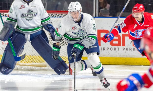 Austin Strand, sporting a full cage, lugs the puck up ice during Seattle's 5-1 loss to Spokane (Bri...