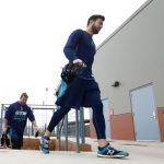 Seattle Mariners outfielders Mitch Haniger, right, and Ben Gamel, left, walk back to the locker room after working out at the Mariners spring training complex Wednesday, Feb. 14, 2018, in Peoria, Ariz. (AP Photo/Ross D. Franklin)
