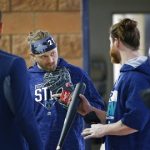 Seattle Mariners outfielder Mitch Haniger, left, infielder Taylor Motter, center, and outfielder Ben Gamel chat as they take a break in the inside batting cages at the Seattle Mariners spring training complex Wednesday, Feb. 14, 2018, in Peoria, Ariz. (AP Photo/Ross D. Franklin)
