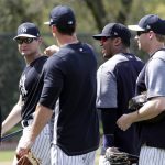 Seattle Seahawks NFL football team quarterback Russell Wilson, second from right, walks on the field with infield coach Carlos Mendoza, second from left, while doing drills at New York Yankees baseball spring training camp, Monday, Feb. 26, 2018, in Tampa, Fla. (AP Photo/Lynne Sladky)