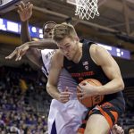 Oregon State's Tres Tinkle, right, holds on to a rebound in front of Washington's Noah Dickerson during the first half of an NCAA college basketball game Thursday, March 1, 2018, in Seattle. (AP Photo/Elaine Thompson)