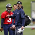 Seattle Seahawks offensive coordinator Brian Schottenheimer, right, gives instructions as quarterback Russell Wilson, left, looks on during NFL football practice, Thursday, May 24, 2018, in Renton, Wash. (AP Photo/Ted S. Warren)