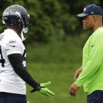 Seattle Seahawks linebacker Bobby Wagner, left, talks with defensive coordinator Ken Norton Jr., right, during NFL football practice Thursday, May 24, 2018, in Renton, Wash. (AP Photo/Ted S. Warren)