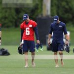 Seattle Seahawks starting quarterback Russell Wilson, right, walks with backups Alex McGough, left, and Austin Davis, second from left, as well as quarterbacks coach Dave Canales, second from right, following NFL football practice, Thursday, May 24, 2018, in Renton, Wash. (AP Photo/Ted S. Warren)