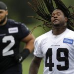Seattle Seahawks linebacker Shaquem Griffin, right, flips his hair as he walks with offensive guard Skyler Phillips, left, following NFL football practice, Thursday, May 24, 2018, in Renton, Wash. (AP Photo/Ted S. Warren)