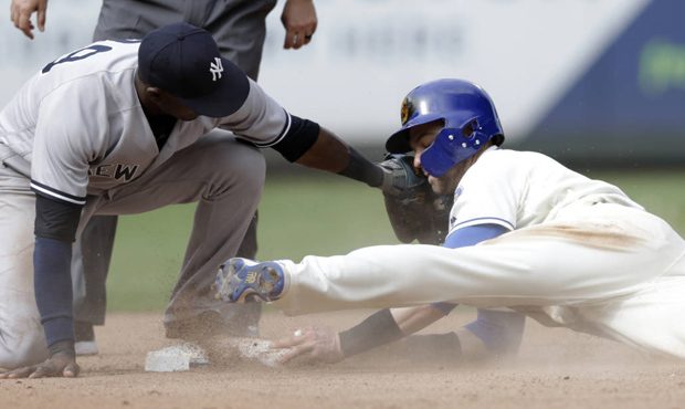 Seattle Mariners' Mitch Haniger steals second before the tag from New York Yankees shortstop Adeiny...