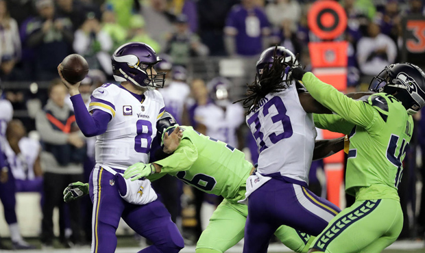 Minnesota Vikings quarterback Kirk Cousins (8) is pressured by Seattle Seahawks' Akeem King in the ...