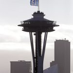 A "12 Flag," a show of support of Seahawks' fans, flutters atop the Space Needle Friday, Jan. 4, 2019, in Seattle. The flag was raised earlier in the day and will fly in celebration of the team's wild card playoff game in Dallas on Saturday against the Cowboys and will remain up through Sunday, Jan. 6. (AP Photo/Elaine Thompson)
