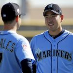 Seattle Mariners pitcher Yusei Kikuchi, from Japan, talks to pitcher Marco Gonzales during spring training baseball practice Tuesday, Feb. 12, 2019, in Peoria, Ariz. (AP Photo/Charlie Riedel)