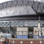 The last letters of "Safeco Field" are removed by a crane over the home plate entrance of the Seattle Mariners' ballpark Wednesday, Feb. 13, 2019, in Seattle. Under a new 25-year naming rights deal, the Mariners will call the stadium T-Mobile Park. The Mariners' ballpark has been known as Safeco Field since it opened in 1999 as part of a 20-year agreement. Safeco Insurance and the Mariners announced in June 2017 that the agreement wouldn't be renewed following the 2018 season. (AP Photo/Elaine Thompson)