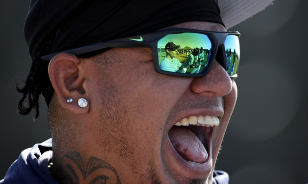 Seattle Mariners starting pitcher Felix Hernandez (34) laughs with teammates during spring training...