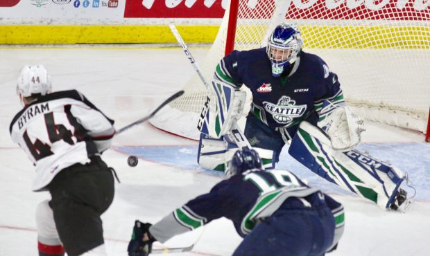 Seattle goaltender Roddy Ross makes a save on Vancouver's Bowen Byram during Friday's Game 5. (Rik ...