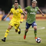 Seattle Sounders' Nicolas Lodeiro, right, dribbles past Columbus Crew's Artur during the second half of an MLS soccer match Saturday, July 6, 2019, in Columbus, Ohio. The Sounders won 2-1. (AP Photo/Jay LaPrete)