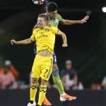 Columbus Crew's Pedro Santos, front, and Seattle Sounders' Xavier Arreaga go up for a head ball during the second half of an MLS soccer match Saturday, July 6, 2019, in Columbus, Ohio. The Sounders won 2-1. (AP Photo/Jay LaPrete)