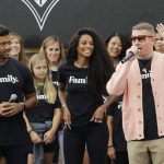 Seattle Seahawks NFL football quarterback Russell Wilson, left, and his wife, pop singer Ciara, center, listen as hip-hop artist Macklemore, right, speaks Monday, Aug. 19, 2019, during an event in Seattle held to introduce themselves and others as new members of the MLS soccer Seattle Sounders team's ownership group. (AP Photo/Ted S. Warren)