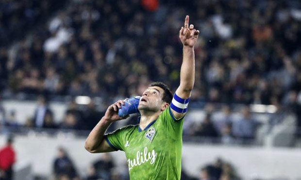 Seattle Sounders midfielder Nicolas Lodeiro celebrates his goal while holding his shoe during the f...