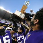 SEATTLE, WASHINGTON - NOVEMBER 29: The Washington Huskies celebrate with the Apple Cup trophy after defeating the Washington State Cougars 31-13 during their game at Husky Stadium on November 29, 2019 in Seattle, Washington. (Photo by Abbie Parr/Getty Images)
