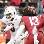 Stanford wide receiver Connor Wedington, left, carries the ball while pressured by Washington State linebacker Jahad Woods during the first half of an NCAA college football game in Pullman, Wash., Saturday, Nov. 16, 2019. (AP Photo/Young Kwak)
